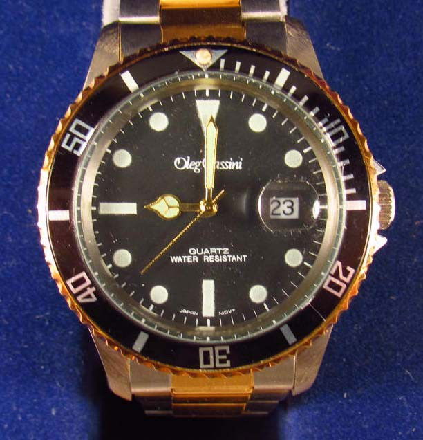 OLEG CASSINI MEN'S WRIST WATCH IN ORIGINAL BOX: W/ Original paperwork.