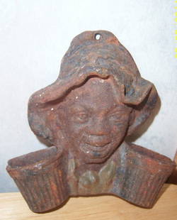 ANTIQUE BLACK AMERICANA WALL MOUNTED MATCHSTICK HOL: ANTIQUE..SMALL WALL MOUNT CAST IRON BLACK LADY WITH THE MOP CAP ON HER HEAD MATCHSTICK HOLDER, SHE HAS 2 LITTLE BASKETS ON BOTH SIDES OF HER SHOULDERS TO HOLD THE MATCHES AND A SMALL HOLE ON THE TOP