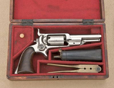 Colt Root side hammer spur trigger revolver,: .28 cal., 3-1/2" octagon barrel, nickel finish, wood grips, #2897; backstrap period inscribed "J.W. Wheeler". This gun shows 96% nickel, considerable cylinder scene, matching serial numbers, very good