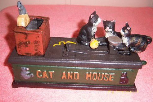 ADORABLE CAST AND MOUSE CAST IRON MECHANICAL BANK,: CAST IRON ADORABLE CAT AND MOUSE BANK..THE TOP HAS 3 KITTIES SITTING AND ONE OF THE KITTY HAS A LITTLE PLATE IN FRONT OF IT WHEN YOU PUSH THE LEVER THE KITTY FLIPS IN THE AIR AND DROPS THE COIN INTO T