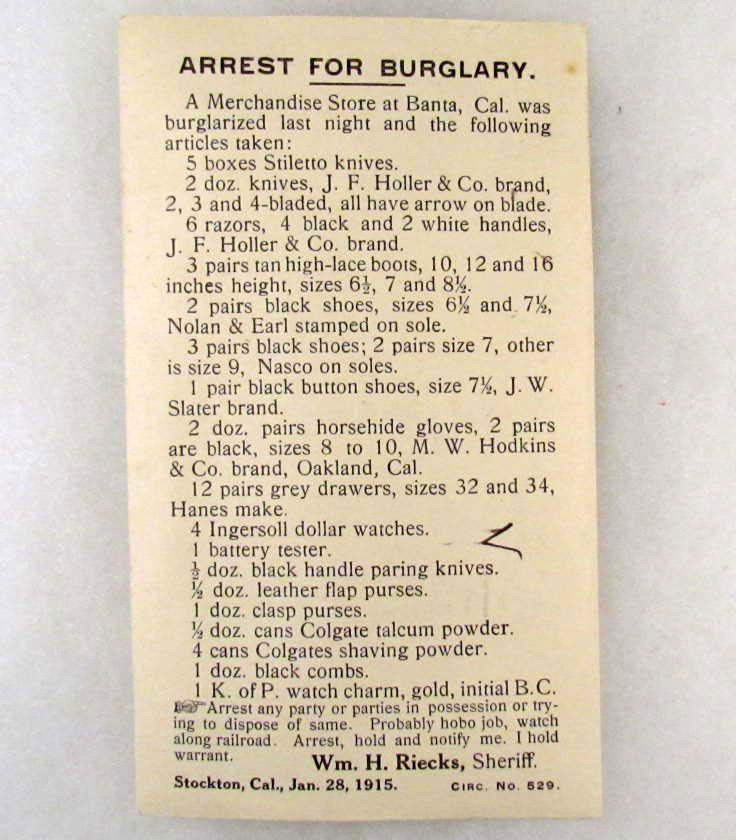 1915 WANTED POSTCARD - ARREST FOR BURGLARY: Postcard lists items that were stolen like 5 boxes Stiletto knives, 6 razors, 3 pairs tan high lace boots, black button shoes, horsehide gloves, more. Believe it to be a hobo job and to watch along th