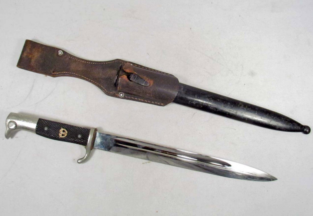 GERMAN NAZI POLICE BAYONET AND SCABBARD WITH LEATH: Measures 15 3/4" long overall. The blade is maker marked Anton Wiggen Jr Solingen. Has the standing Knight logo in the center. The handle has a police emblem mounted on front.