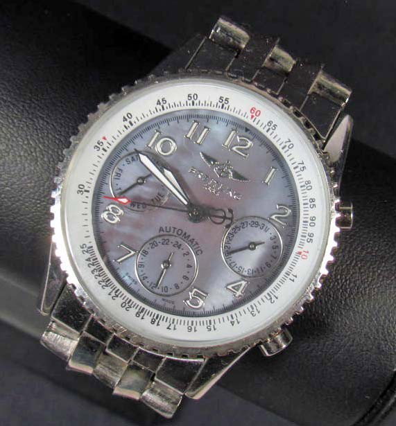 BREITLING MANS WRIST WATCH W/ WRIST BAND: The face is approx. 1 5/16" in diameter. It reads Breitling 1884 Automatic Swiss Made. The back cover reads Breitling 1884 Chronegraphe Certifie Chronometer Etanche 30 M A19340. The wrist band is also