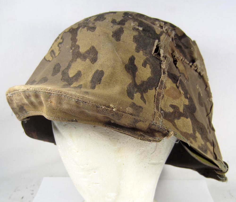 GERMAN NAZI SS MODEL 42 HELMET W/ OAK LEAF PATTERN: Rocker clips intact. liner band is dated 1943.