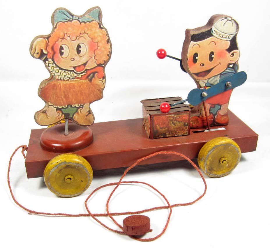 VINTAGE TIN CHILD'S PULL TOY: When rolling, front girl spins in a circle and the second boy playing his instrument. All metal toy w/ wooden figures.