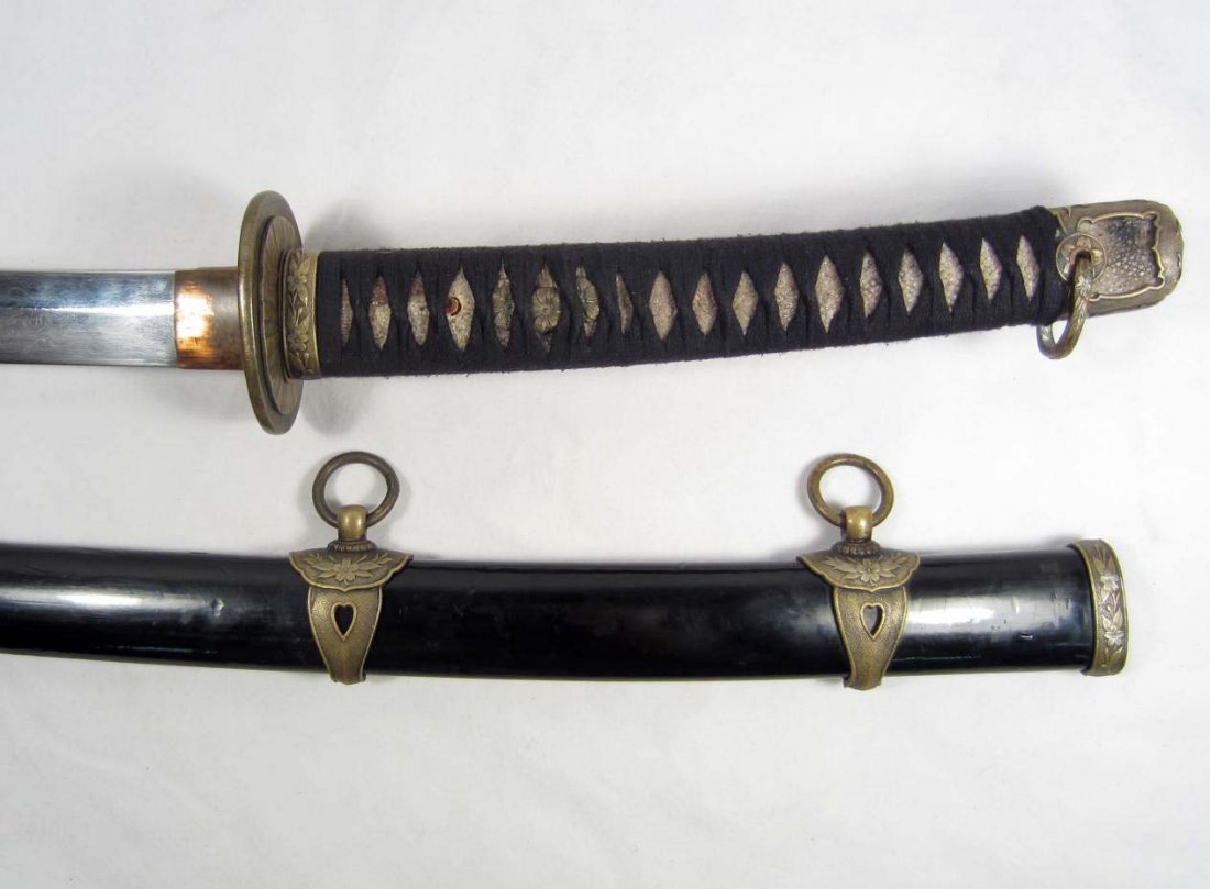 JAPANESE NAVAL OFFICERS SAMURAI SWORD W/ SCABBARD: Approx. 41.5" long overall. The steel blade is approx. 28" long. The tang is sword smith maker marked w/ four Japanese characters. Includes the brass tsuba sword guard. The handle is ray skin covered 