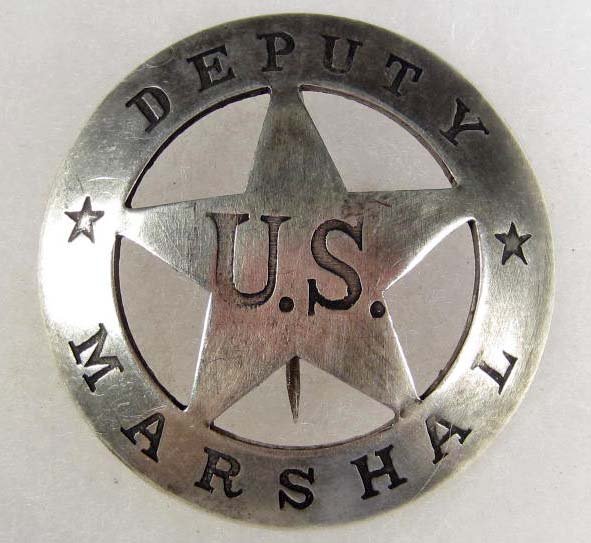 OLD WEST US DEPUTY MARSHAL COWBOY ERA LAW BADGE: Approx. 2 5/16" in diameter. Pinback. Has a cut out star in the center surrounded by a round rim. nickel construction.