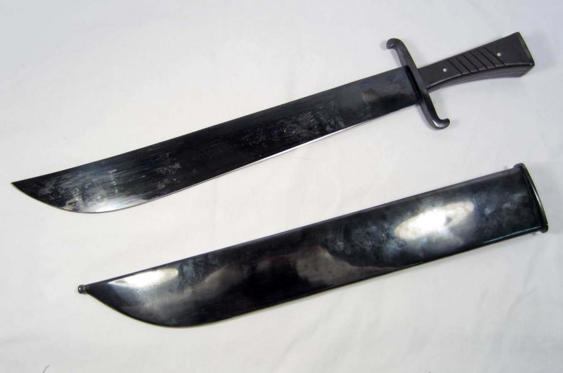 GERMAN NAZI LUFTWAFFE COMBAT SURVIVAL MACHETE W/ S: Approx. 21 5/8" long overall. The blued steel blade is approx. 16 1/8" long. The scabbard is blued steel. Has a pair of dark walnut wood grips. Nice condition.