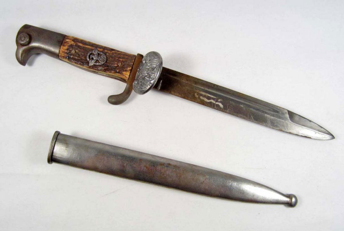 RARE GERMAN NAZI POLICE CLAM SHELL BAYONET W/ SCAB: Approx. 14" long overall. The steel blade is unmarked. Has a pair of stag antler grips w/ the police insignia in the center. The eagle clam shell is below the cross guard. The scabbard is steel constr