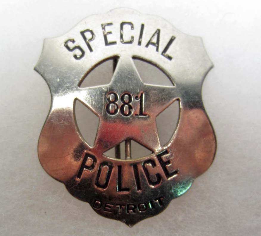 DETROIT MICHIGAN SPECIAL POLICE OFFICER #881 LAW BA: Approx. 2 3/16" by 2 11/16". Pinback. Nickel construction. This is a shield shaped badge w/ a cut out star in the center.