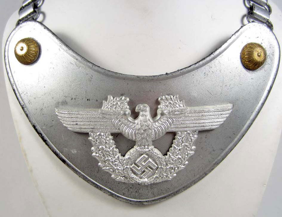 RARE GERMAN NAZI POLICE GORGET W/ NECK CHAIN: Gorget is approx. 4" tall by 6.5" wide. One of the clips on the reverse side is maker marked A for Assmann. Has a grey wool backing. Steel construction. Includes a steel neck chain that is approx. 25.