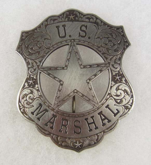 RARE OLD WEST US MARSHAL ENGRAVED COWBOY ERA LAW BA: Approx. 2 3/16" by 2 11/16". The front reads US marshal and is finely hand engraved w/ swirls. This is a shield shaped badge w/ a cut out star in the center. Pinback. Nickel construction.