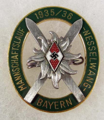 GERMAN NAZI HITLER YOUTH HJ ALPINE SKI BADGE: Pinback. Maker marked h & Co Munchen. Two piece riveted nickel and brass construction w/ enamel.