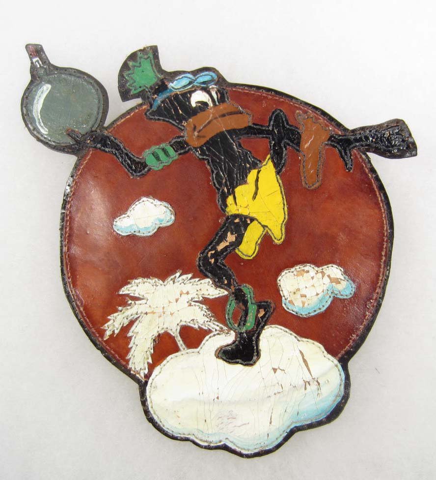 USAAF ARMY AIR CORPS 5TH AIR FORCE LEATHER BOMB SQU: Shows a native standing on a island throwing a bomb. Multi-piece hand painted leather construction. This was to have been worn on the breast of an A-2 leather flight jacket