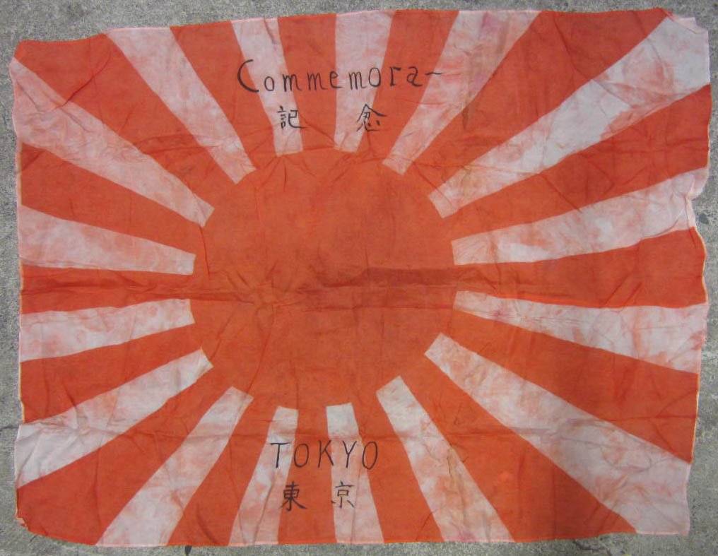 JAPANESE TOKYO SILK BATTLE FLAG: Approx. 26 5/8" by 35". The flag reads Tokyo Commemora along w/ other japanese writing. Silk construction. From a USMC WW2 marine Corps Soldiers Estate