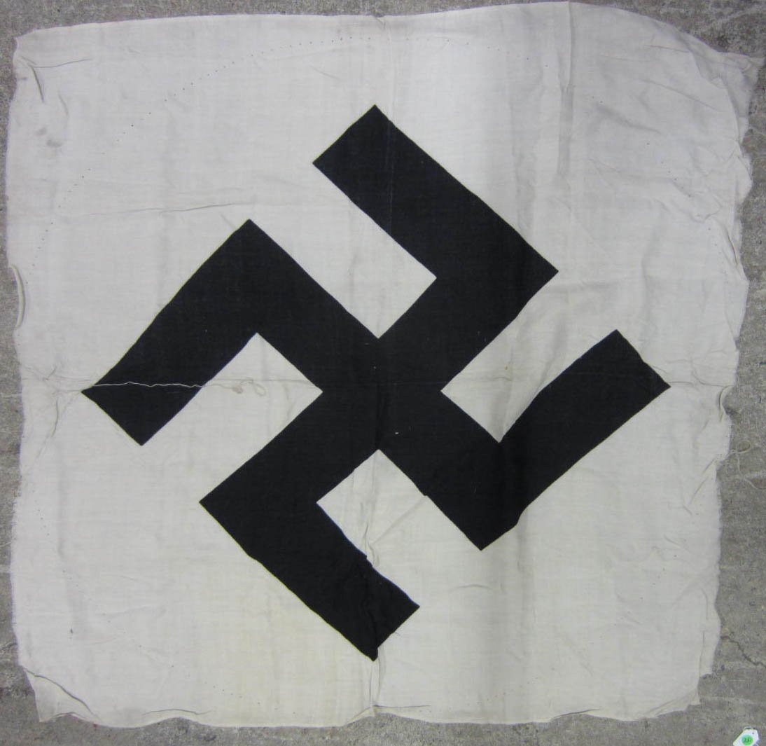 GERMAN NAZI LARGE SWASTIKA FLAG CENTER TO A POLITI: Approx. 46.5" by 45.5". Printed cotton construction. From a WW2 veterans estate.