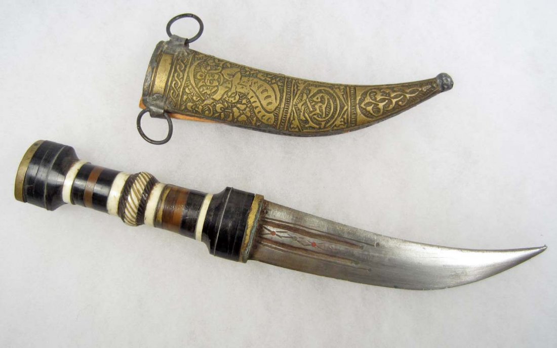 EARLY MIDDLE EASTERN FIGHTING KNIFE W/ INLAY HANDL: Metal sheath is elaborately embossed. Some condition issues. Approx. 11" long overall