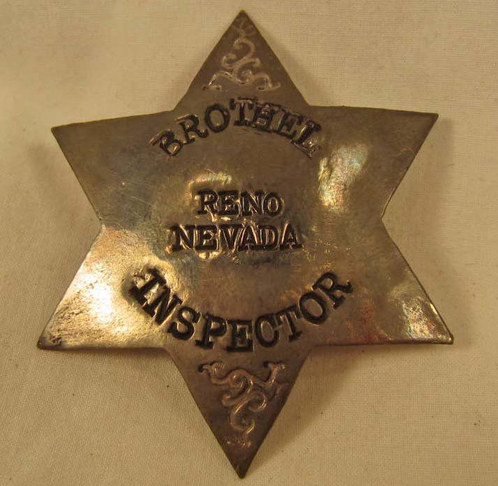 RENO NEVADA BROTHEL INSPECTOR BADGE: Pinback. Approx. 2 3/8" diameter. Six pointed star. Nickel construction