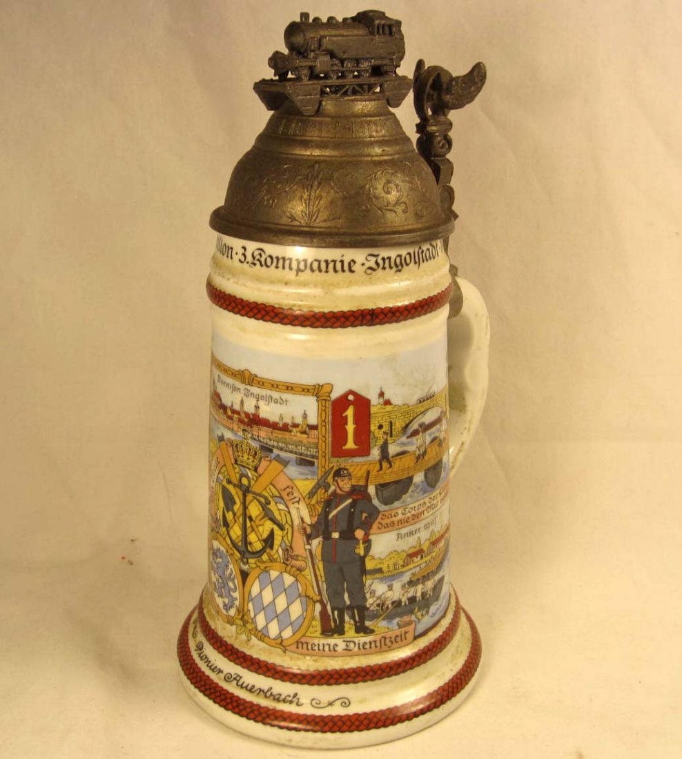 IMPERIAL GERMAN BAVARIAN TRAIN BATTALION REGIMENTA: Approx. 9 5/8" tall by 4 5/8" diameter. Named to a Pioneer Auenback and dated 1911 - 1913. The base has a lithopane scene of a soldier and a woman. Lid is pewter w/ a train on the top.
