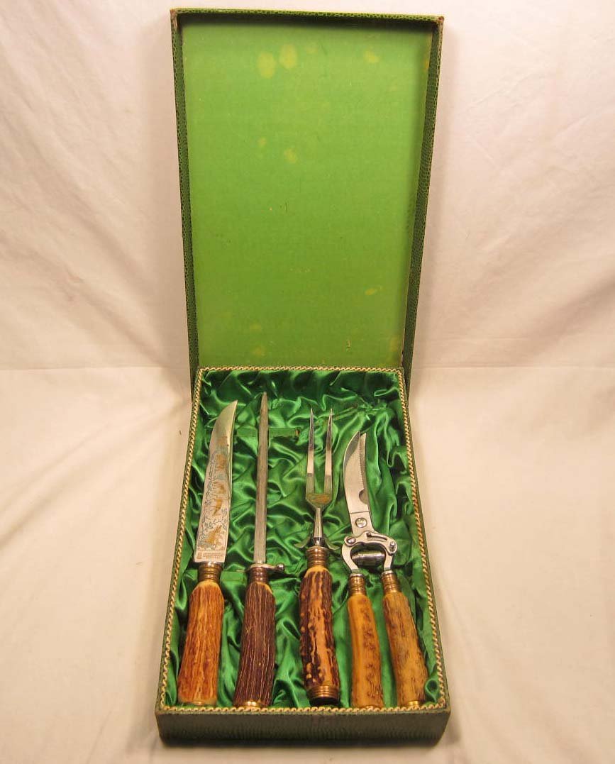 EARLY GERMAN NAZI MEAT CARVING SET W/ CASE: Fancy engraved knife, sharpener, fork and cutter. Maker marked Anton Wiggen Jr Solingen - Germany Rostfrei. The cardboard case is approx. 8 1/4" by 14 3/16" by 1 3/4"