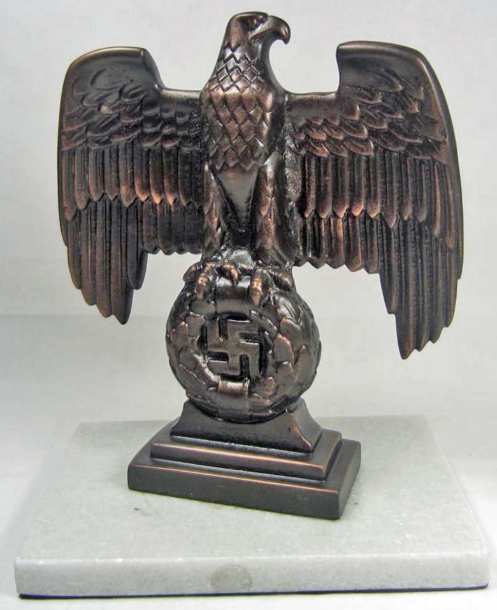 GERMAN NAZI NURNBERG DESK EAGLE: Approx. 7 3/8" tall by 6" wide. Mounted on a white marble base. The back is maker marked RZM M3/90. Metal construction.