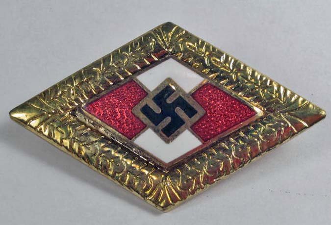 GERMAN NAZI GOLD HITLER YOUTH HJ HONOR BADGE: With Oak Leaf Wreath. Pinback. maker marked RZM BM1/122. Approx. 1" by 1.5". Two piece brass and enamel construction.