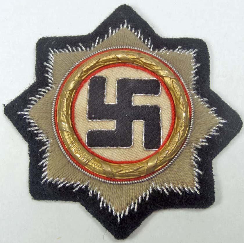 GERMAN NAZI SS PANZER CLOTH GERMAN CROSS IN GOLD: Approx. 2 7/8" in diameter. The reverse is maker marked JFS 43. Silver bullion wire and cotton thread embroidered on a black wool backing. Metal brass wreath that is dated 1941
