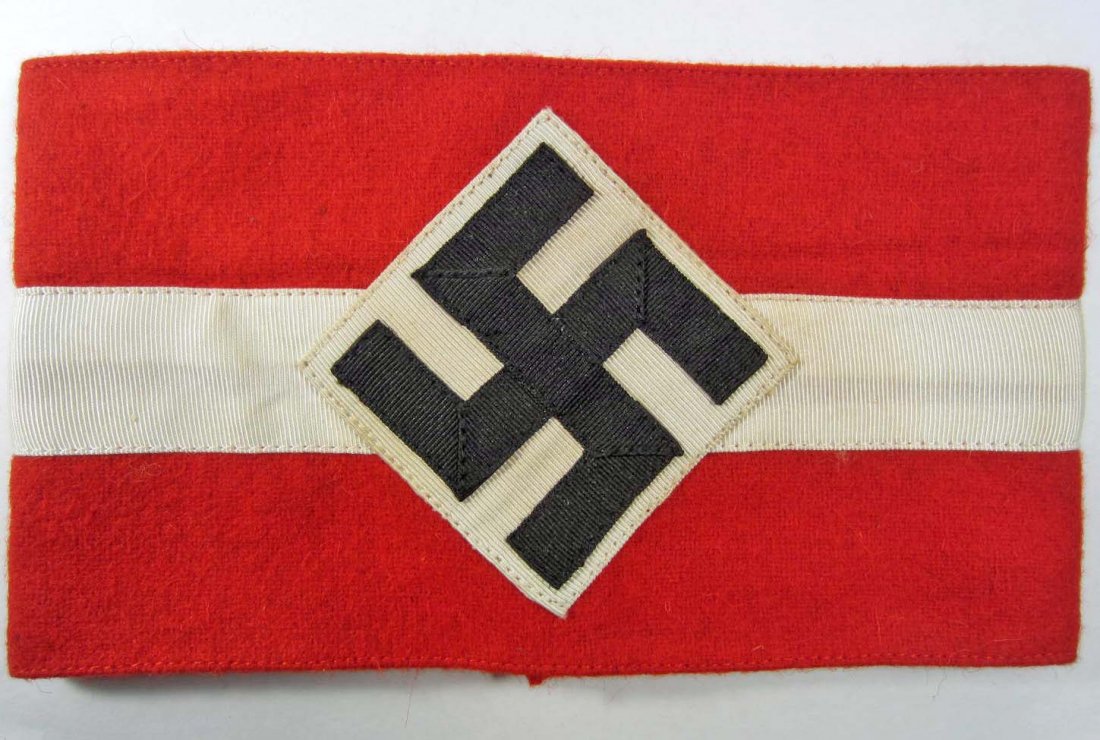 GERMAN NAZI HITLER YOUTH HJ ARM BAND: Approx. 4 5/8" by 7 1/4". Cotton and wool. Has a paper RZM Hitler Youth HJ tag on the inside.