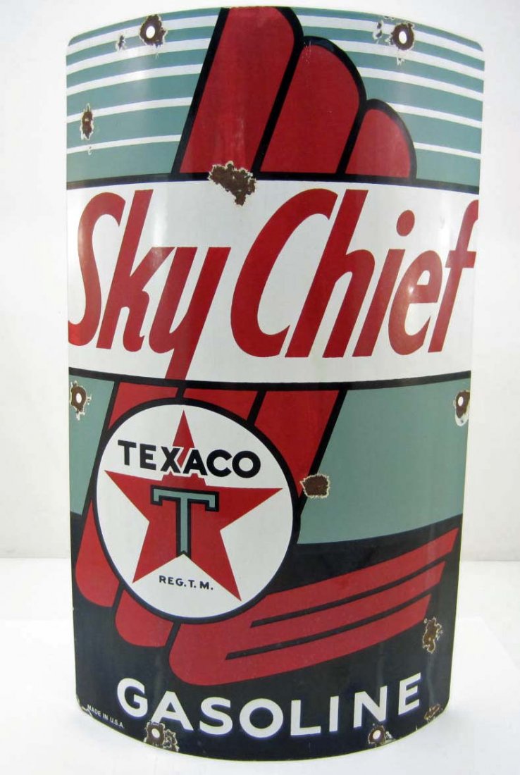 TEXACO SKY CHIEF GASOLINE PORCELAIN ADVERTISING SIGN: Approx. 10 9/16" by 18". The front reads Sky Chief Texaco Reg T M Gasoline Made in USA. Has some dings to the body. The sign is curved for securing to the gas pump. Very nice for display