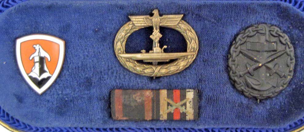 CASED GERMAN NAZI NAVAL U-BOAT SUBMARINE BADGE: maker marked Schwerin Berlin 68. Includes a Naval Black Wound badge and a two place ribbon bar. Also included is a Flotilla submarine enameled polar bear badge. All have pinbacks. The leatherette case