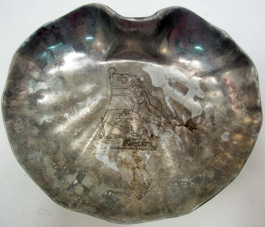 GERMAN NAZI NAVAL PRESENTATION TRAY: Approx. 9 1/4" tall by 11 1/2" wide by 1 1/2" deep. The center is engraved w/ German battle flag and has a battle ship below. It reads Einsatz Deuthschen Kriegsmarine. Metal construction.