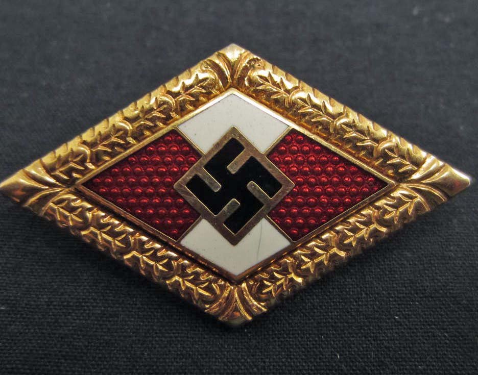 GERMAN NAZI HITLER YOUTH HJ GOLDEN HONOR BADGE: Pinback. Two piece brass and enamel construction.