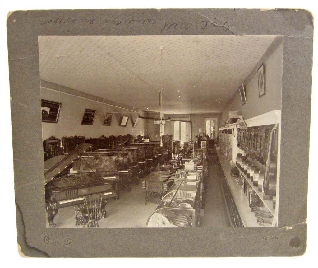 1900 LARGE MOUNTED PHOTOGRAPH OF A MUSIC STORE INTERIOR: Lots of Musical Instruments AND SEWING MACHINES!
