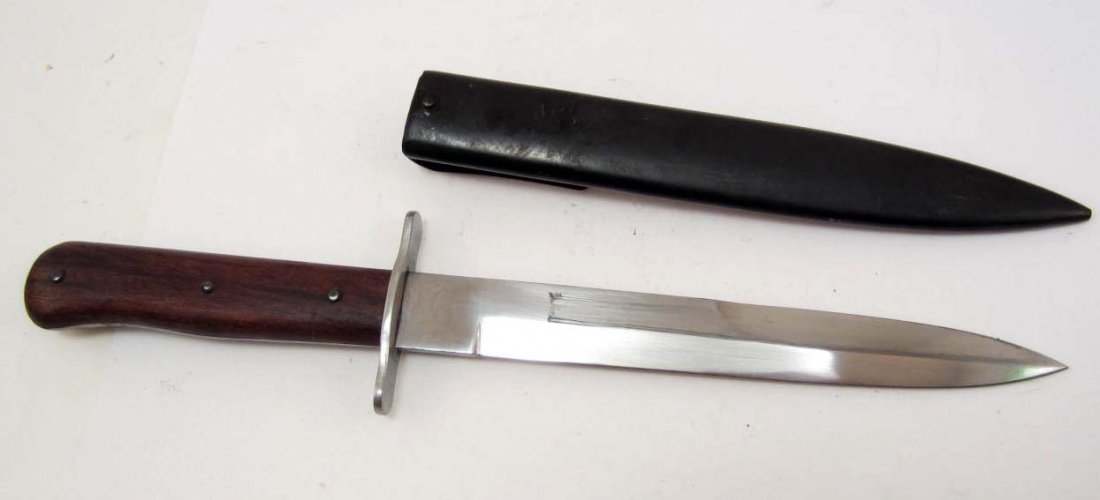 GERMAN NAZI ARMY COMBAT BOOT KNIFE W/ SCABBARD: Approx. 11 13/16" long overall. The steel blade is approx. 7/8" by 6 7/8". Has a blued steel scabbard w/ a belt clip. The cross guard is nickel construction w/ a pair of wood handles. Rare.