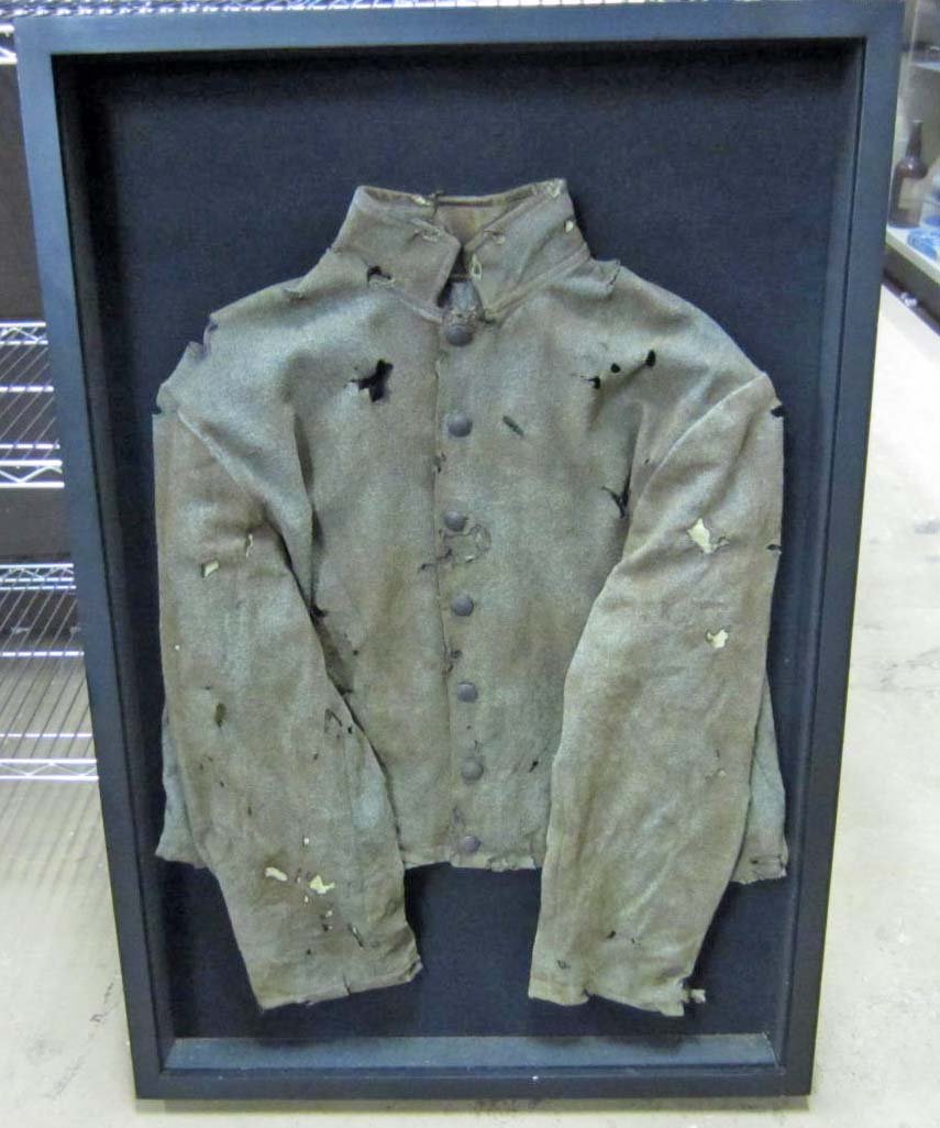 FRAMED CONFEDERATE STATES ARMY CIVIL WAR COMBAT EM: Uniform is wool w/ cotton liner. 7 hollow brass buttons on the front read CSA. Medium jacket. Shows use and wear. For an enlisted man. Excellent for display. Rare.