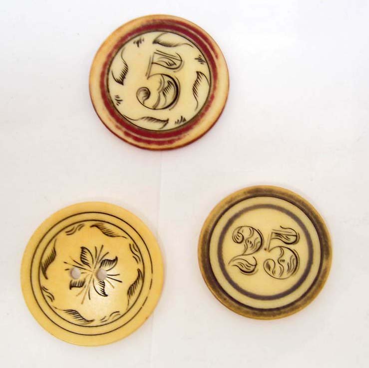 LOT OF 3 C. 1850'S IVORY GAMBLING POKER CHIPS: $5, $25 and one w/ floral design.Approx. 1 9/16" diameter. Scrimshawed w/ the dollar denomination. RARE
