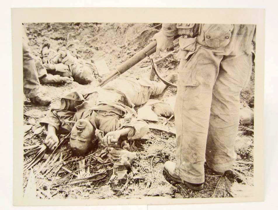 WW2 GRUESOME PHOTO OF DEAD JAPANESE SOLDIERS: US Soldier stading over w/ M1 Rifle. Approx. 4.5" by 3.5"