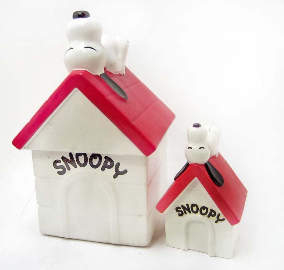 COOKIE JAR AND MATCHING BANK - SNOOPY DOG HOUSE - MCCOY: An excellent lot of two Snoopy items. A matching Snoopy cookie jar and bank. The cookie jar measures approximately 11" tall. The Snoopy bank measures approxiately 6" tall. The cookie jar is marked on