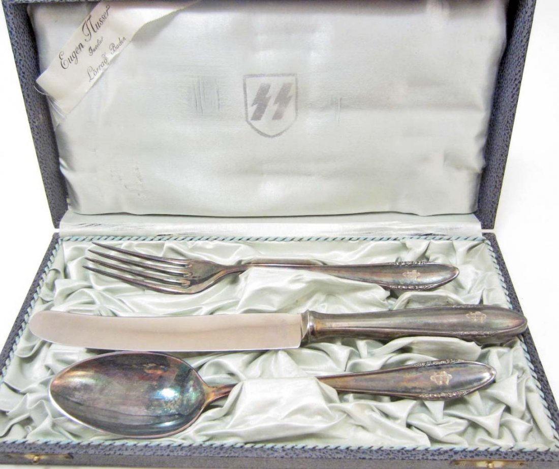 CASED GERMAN NAZI WAFFEN SS OFFICERS SKORZENY: Includes a fork, knife and spoon. The fork and spoon are maker marked BSF 90 Platuma. The knife is maker marked BSF 90 Rostfrei. All three have the hand engraved initials on the front base that reads 