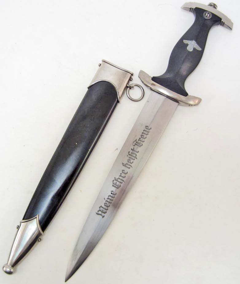 GERMAN NAZI WAFFEN SS ENLISTED MANS DAGGER W/ SCABBARD: Approx. 14 13/16" long overall. Has a black ebony wood handle w/ metal Nazi eagle in the center and enameled ss runics at the top. The front of the steel blade is etched and reads Meine Ehre Heisst Tr