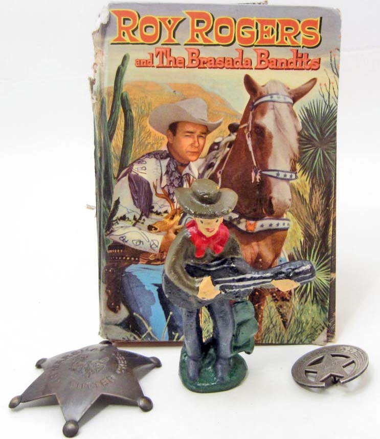 LOT OF WESTERN BADGES, ROY ROGERS BOOK & CAST IRON: A lot of miscellaneous Western inspired collectibles! Western US Marshal Sutter Creek badge, Special Police badge moon & star shaped, Cast Iron cowboy bottle opener, 1955 Roy Rogers and the Brasada Ba