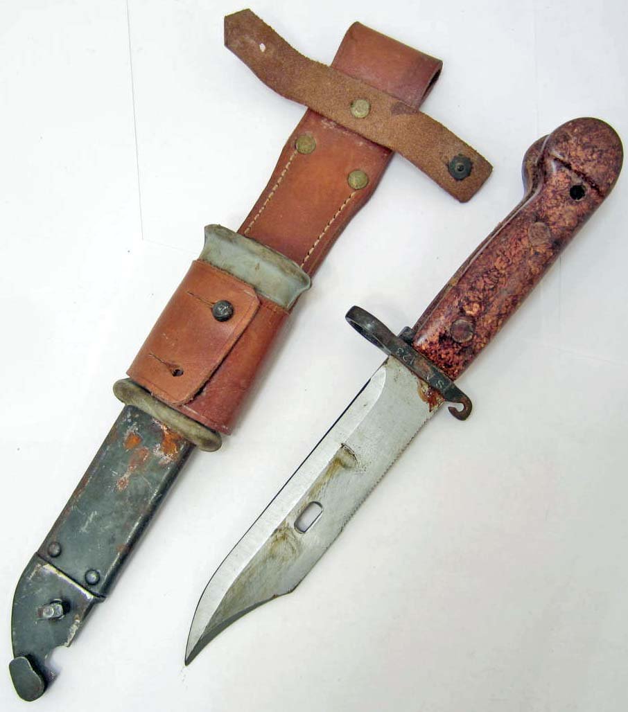 NORTH VIETNAMESE ARMY VC AK 47 MACHINE GUN BAYONET: NVA Viet Cong Boyonet w/ Scabbard. Approx. 13.25" long overall. Steel blade is approx. 1 1/8" wide by 5 7/8" long. Includes the steel scabbard w/ leather belt frog. Bayonet and scabbard had matching n