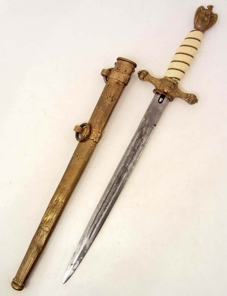 GERMAN NAZI NAVAL U-BOAT SUBMARINE OFFICERS DAGGER: W/ SCABBARD. Measures 16 1/2" long overall. The double etched steel blade has a naval anchor & floral motif on both sides. It is maker marked Original Eickhorn Solingen with their squirrel logo above.