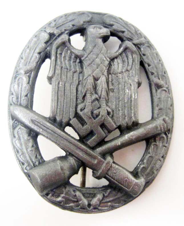 GERMAN NAZI ARMY SILVER GENERAL ASSAULT BADGE: Has a thin vertical pinback. maker marked GWL. Shows an eagle in the center with a crossed grenade and bayonet below surrounded by an oval oak leaf wreath.