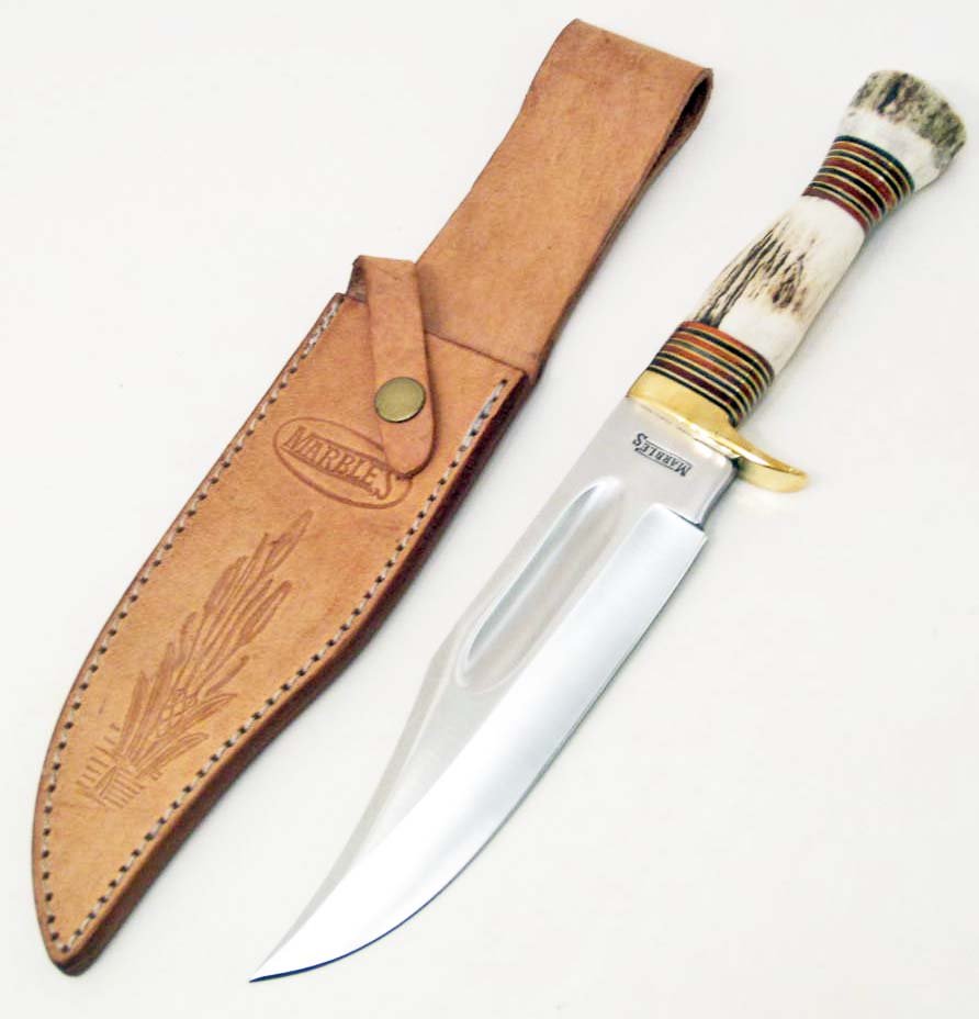 MARBLES IDEAL BOWIE KNIFE W/ STAG HANDLE: Approx. 12 3/4" overall. 7 1/2" stainless blade. Stag handle with brass finger guard. Tan leather belt sheath.