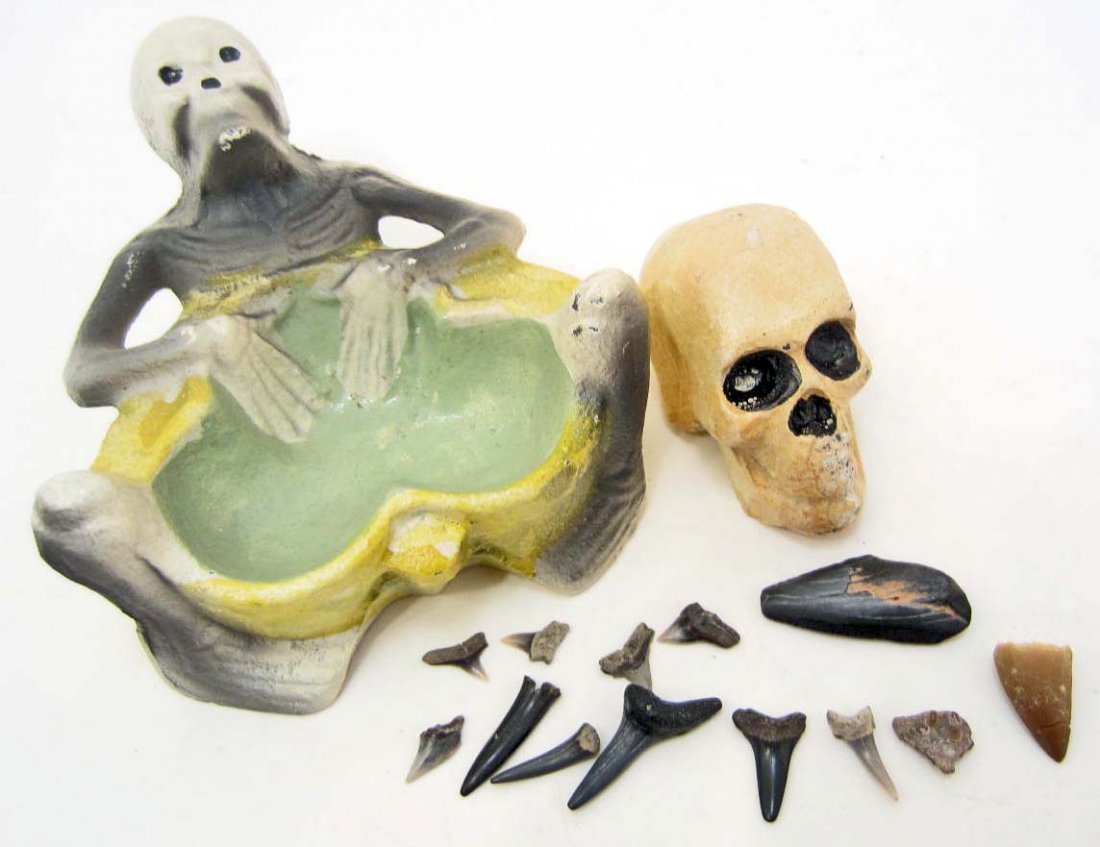 LOT OF MISC. CAST IRON SKULLS & FOSSILIZED TEETH: Cast iron skull paper weight, Cast iron skull coin tray, Million+ years old shark teeth of various shapes & sizes, Million+ years old dinosaur tooth, Million+ years old small fish jaw