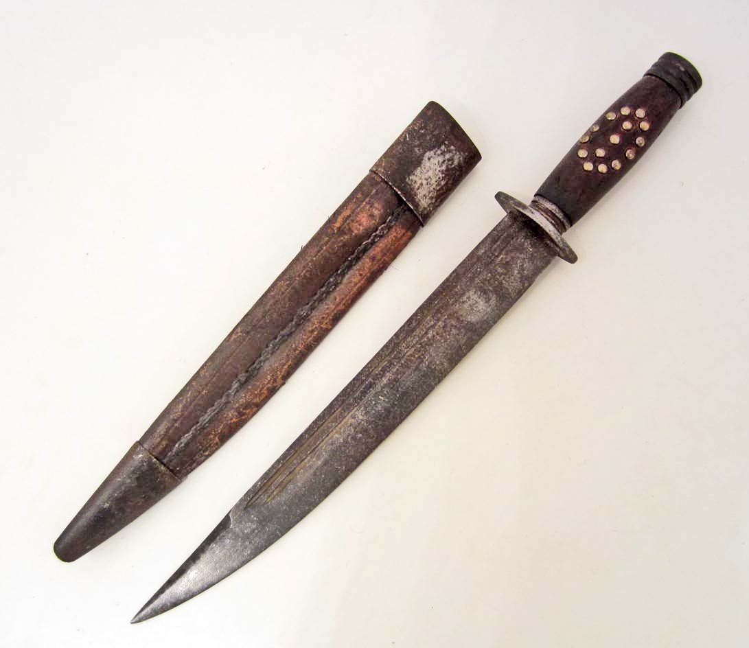CONFEDERATE STATES ARMY CIVIL WAR COMBAT BOWIE KNIFE: W/ SCABBARD. Approx. 15" long overall. The steel blade is marked CSA and is approx. 1 1/4" wide by 9 15/16" long. Has a wood handle w/ 15 small brass tacks on both sides. Hasa steel pommel and cross g