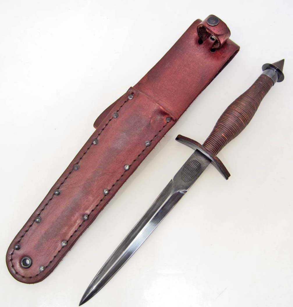 US ARMY FIRST SPECIAL SERVICE FORCE FSSF V-42 KNIFE: W/ SCABBARD. This combat knife measures 12 5/8" long overall. The blued steel blade has the thumb print at the base. It measures 13/16" wide by 7 1/8" long. The handle is leather construction. The cro