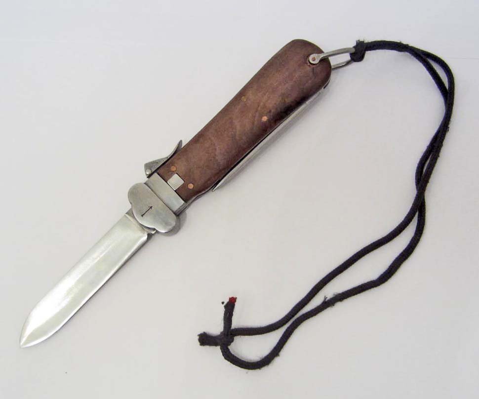 GERMAN NAZI LUFTWAFFE PARATROOPER GRAVITY KNIFE: FALLSCHIRMJAGER GRAVITY KNIFE. Measures 10 3/16" long with the blade open. The steel blade measures 7/8" wide by 4 3/16" long. The nickel spike is marked with the eagle 6 and RB N 0/0561/0010. Has a p