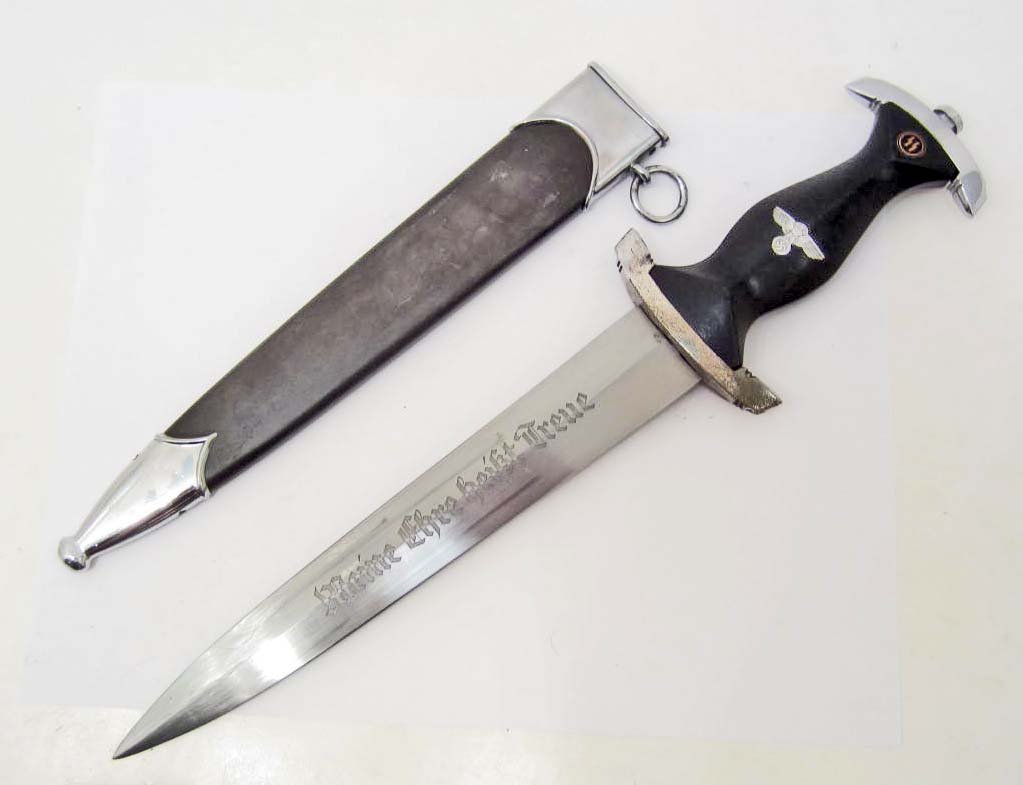 GERMAN NAZI WAFFEN SS ENLISTED MANS DAGGER W/ SCABBARD: Measures 14 3/4" long overall. The etched steel blade reads Meine Ehre heisst Treue (My Honor is Loyalty). It is maker marked SS 807/36 SS. Measures 1 5/16" wide by 8 ¾" long. Has a blue anodized ste